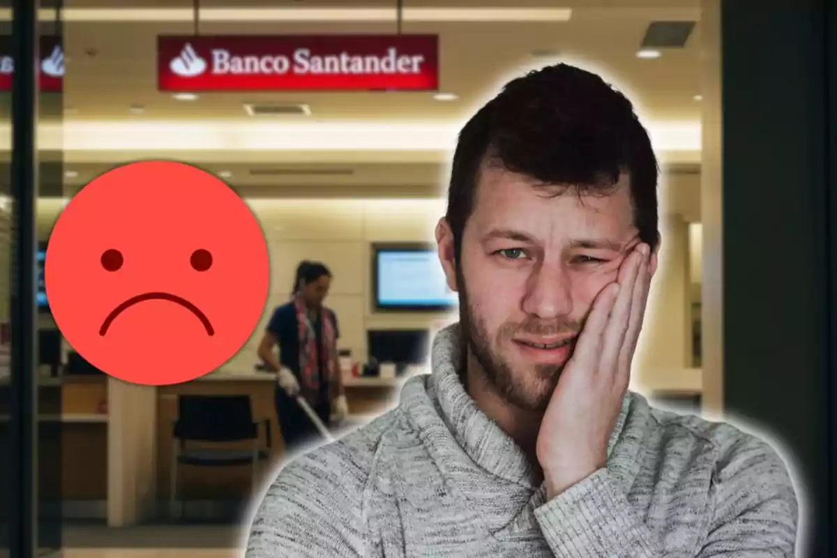 Home amb expressió de molèstia davant d’una sucursal del Banc Santander acompanyat d’un emoji trist