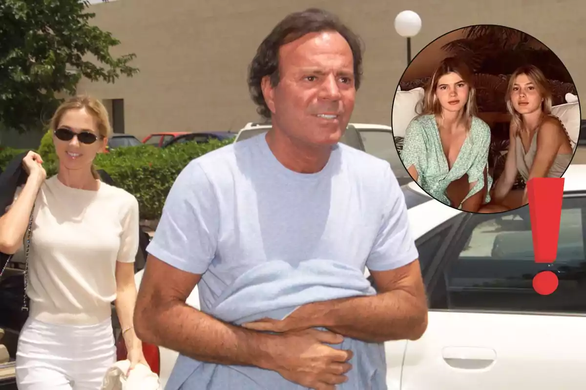 Julio Iglesias de camiseta azul claro caminando junto a Miranda Rijnsburger rubia con gafas de sol y ropa clara, al fondo un coche blanco y un recuadro con sus dos hijas sentadas junto a un signo de exclamación rojo