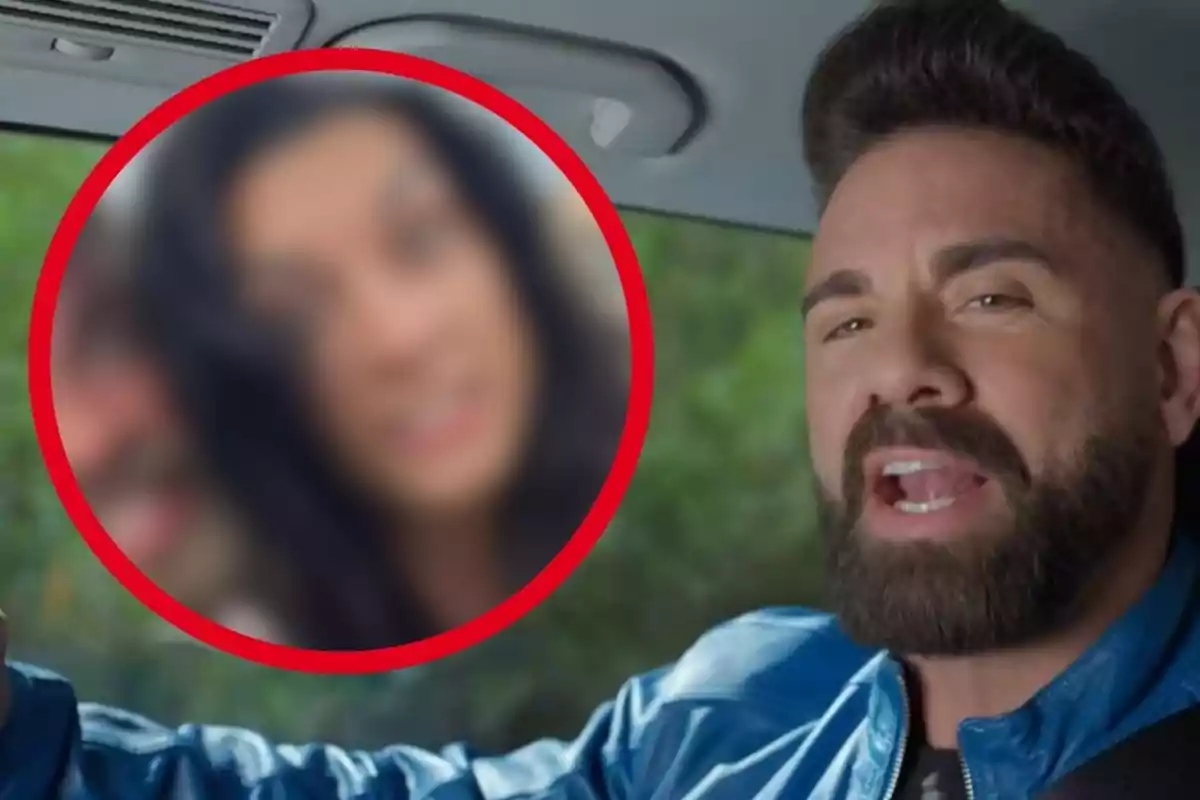 Man with a beard and a blue jacket sitting in a car while a blurry image of a woman appears inside a red circle next to him