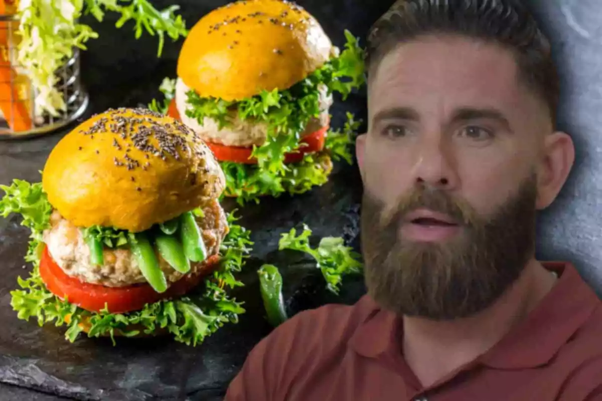 Hamburguesas con pan amarillo y vegetales frescos junto a Marc Ribas de barba y cabello corto que parece sorprendido Hamburguesas con pan amarillo y vegetales frescos junto a Marc Ribas de barba y cabello corto que parece sorprendido