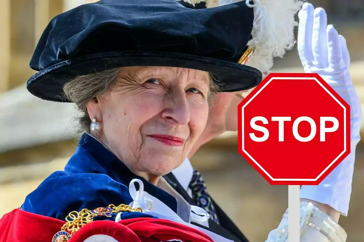 Dona gran amb barret elegant i vestimenta formal sostenint un senyal d’stop vermell que diu STOP