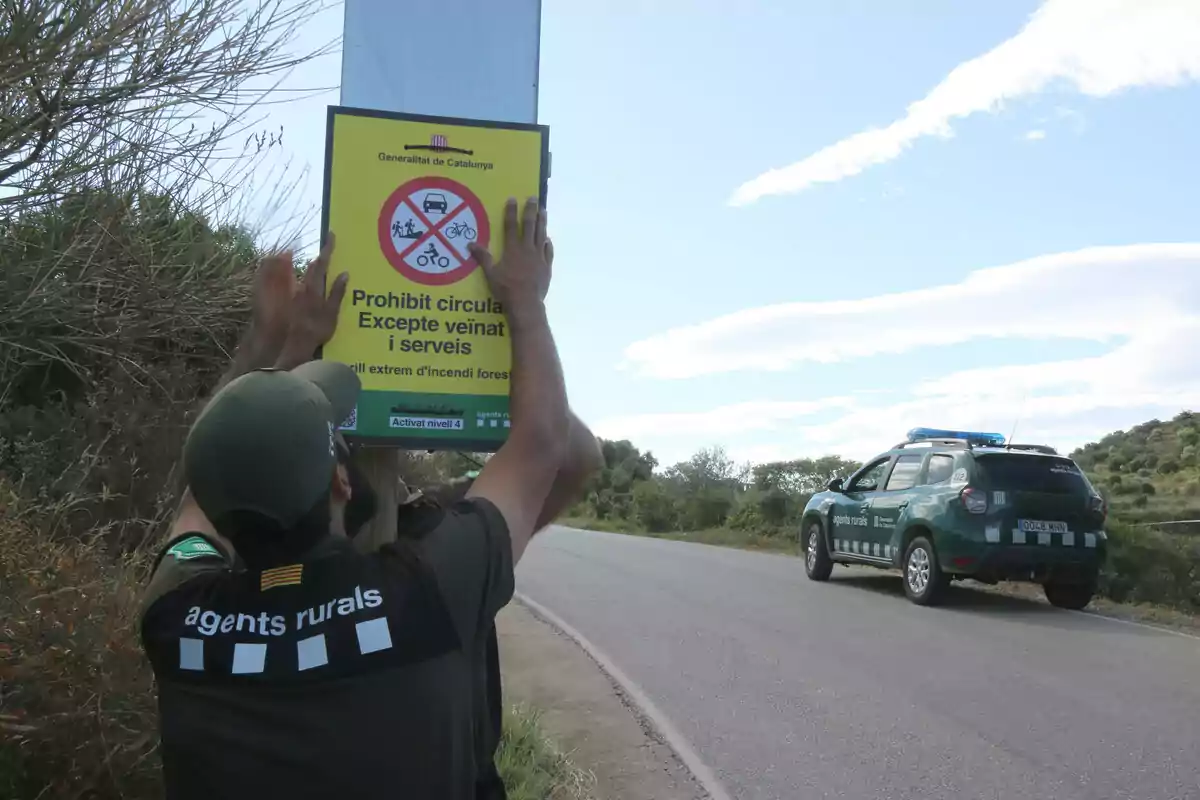 Dos Agents Rurals colocando un cartel informando de la prohibición de circulación en Cap de Creus Dos Agents Rurals colocando un cartel informando de la prohibición de circulación en Cap de Creus