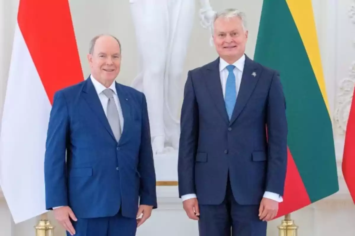 Prince Albert of Monaco and Gitanas Nauseda, President of Lithuania, pose together in their suits in front of their national flags and a white statue. Prince Albert of Monaco and Gitanas Nauseda, President of Lithuania, pose together in their suits in front of their national flags and a white statue.