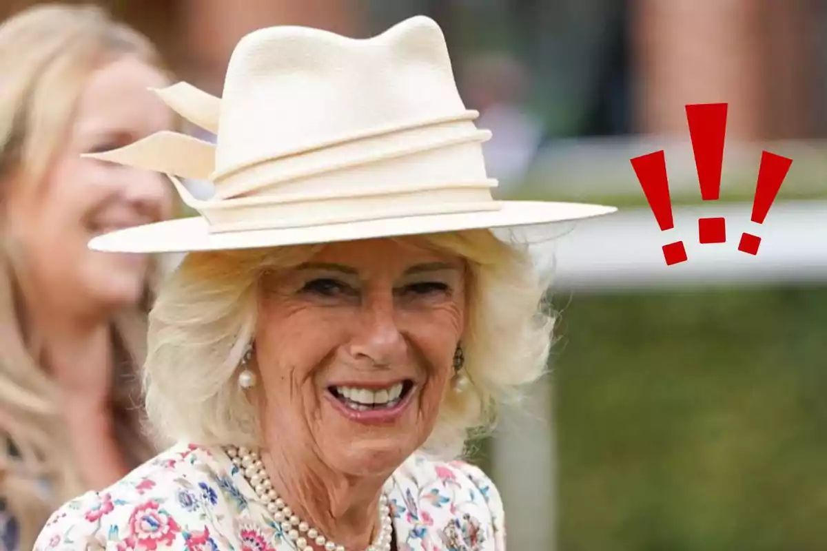 Smiling older woman wearing an elegant white hat and a pearl necklace, with a blurred woman in the background and three red exclamation marks.
