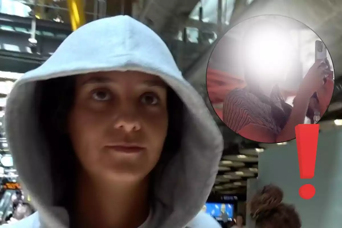 Victoria Federica con sudadera gris y capucha en un lugar público con un círculo que muestra a otra persona tomando una foto y un signo de exclamación rojo