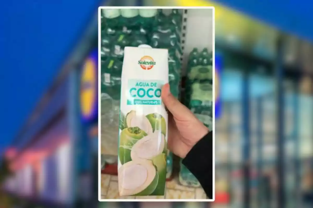 Persona sostenint un envàs d’aigua de coco de la marca Solevita en un supermercat Persona sostenint un envàs d’aigua de coco de la marca Solevita en un supermercat