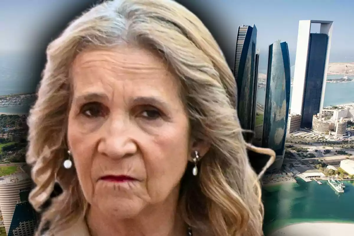 Primer pla de la infanta Elena amb expressió seriosa davant de gratacels moderns al costat de la costa, que és una zona d'Abu Dhabi.