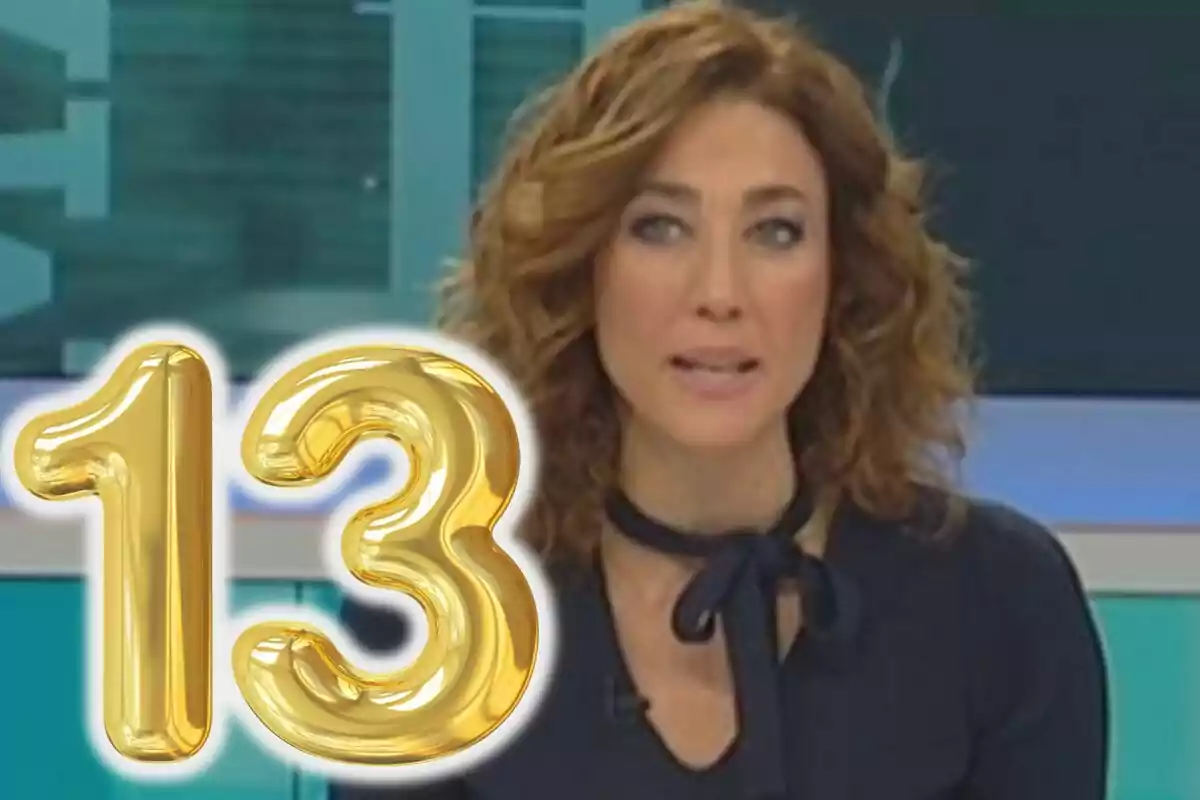 Dona de cabell arrissat castany en un plató de televisió amb un globus daurat en forma de número 13 al davant