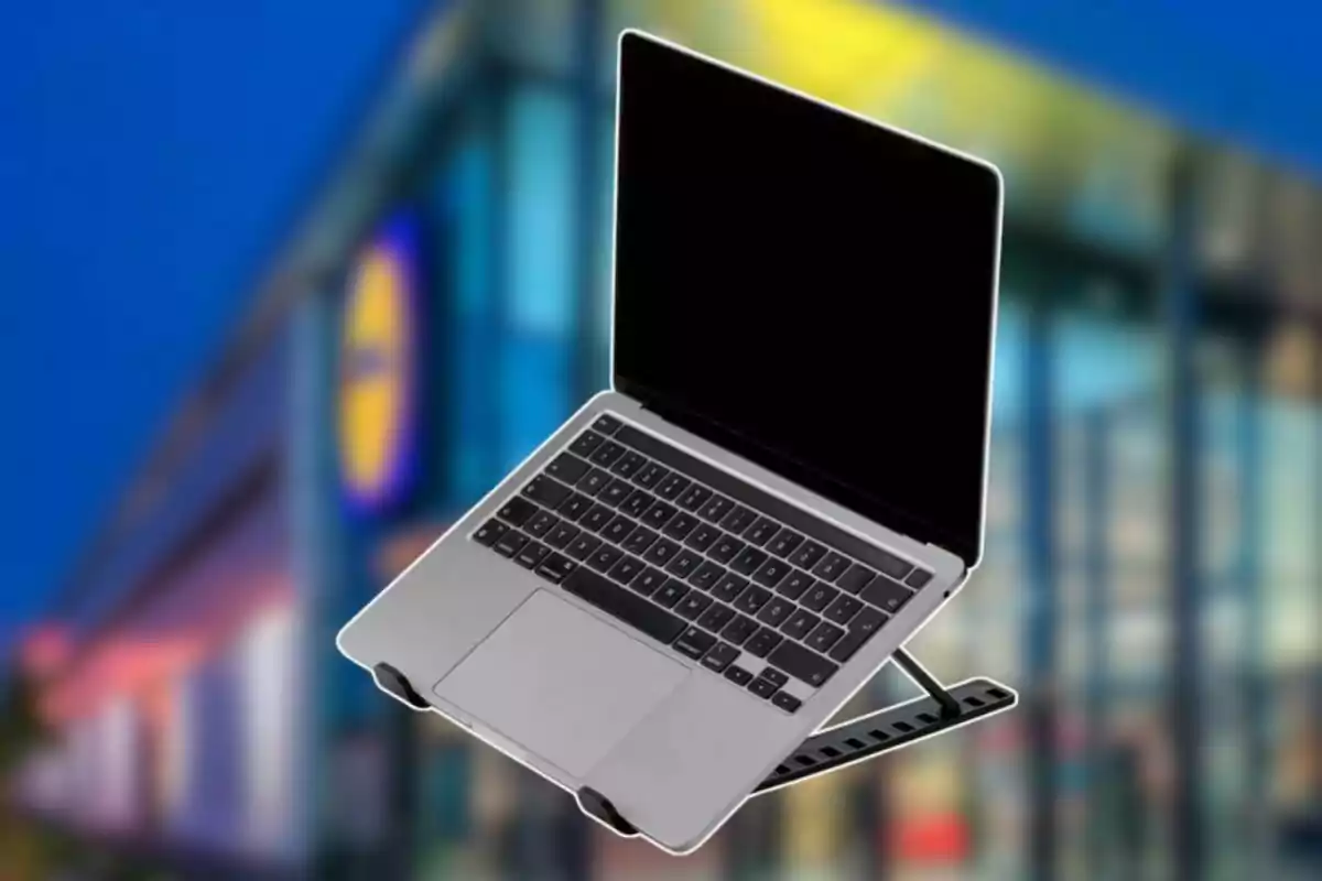 Laptop on a stand with a blurred building in the background Laptop on a stand with a blurred building in the background