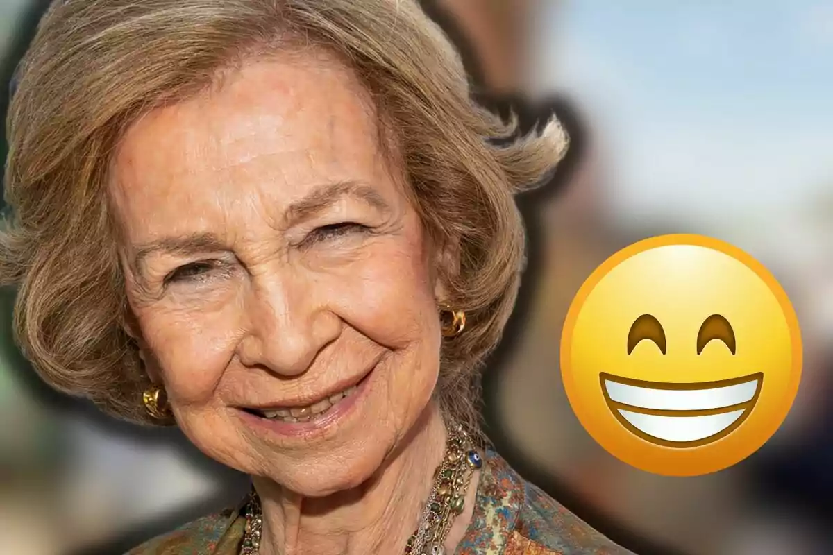 Queen Sofía smiling with a big smiling face emoji next to her