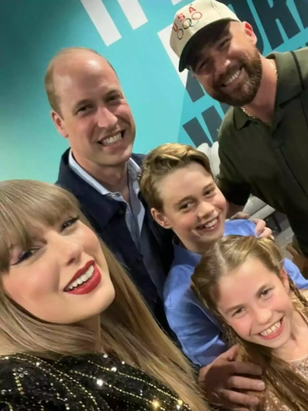 Cinco personas sonríen y posan juntas para una selfie en un ambiente interior con fondo azul Cinco personas sonríen y posan juntas para una selfie en un ambiente interior con fondo azul
