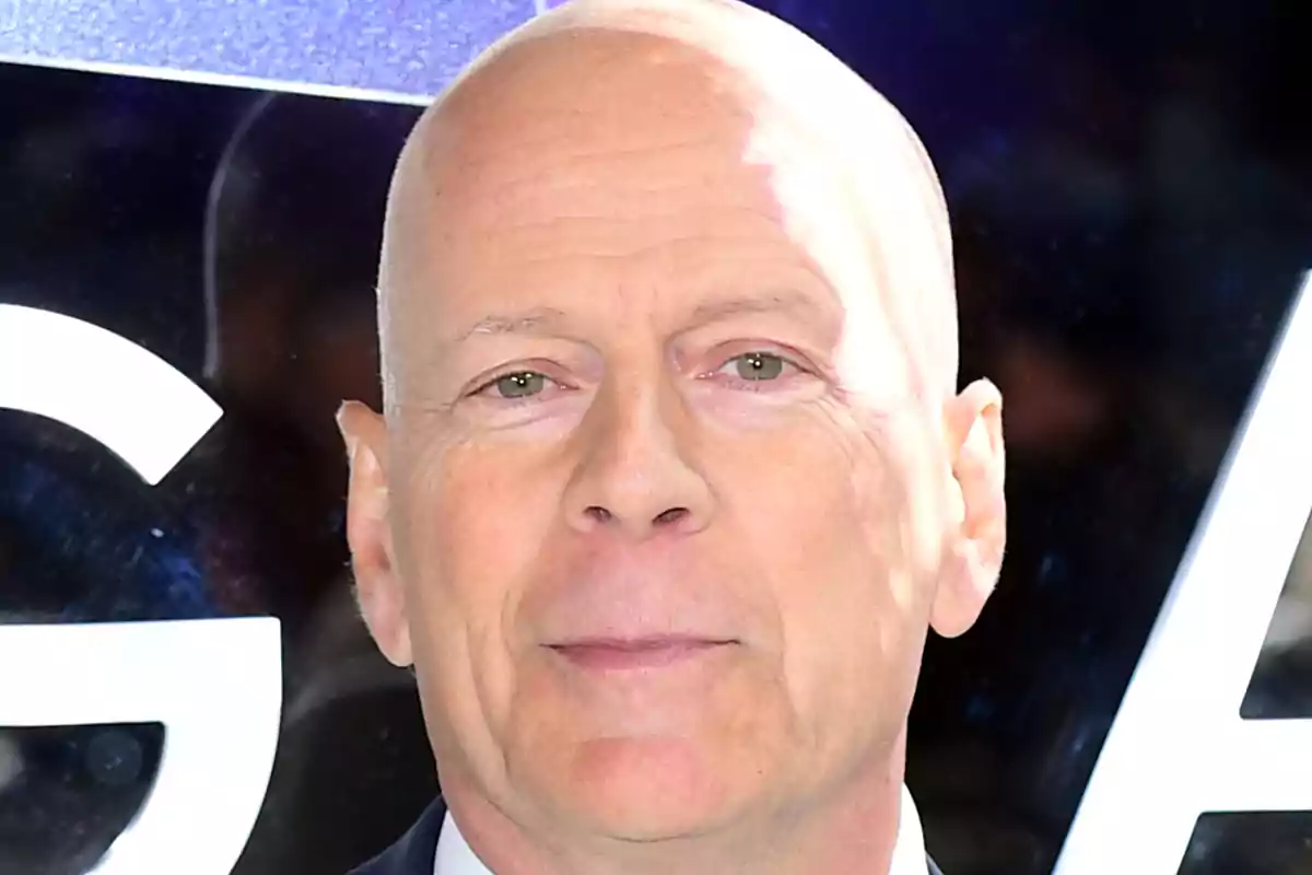 Bruce Willis with a serious expression and a dark background