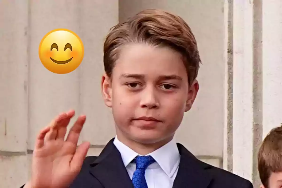 Boy in a suit and blue tie waving while a smiling emoji appears next to him