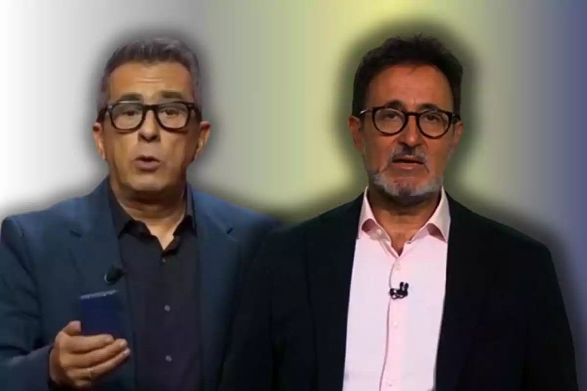 Dos hombres con gafas y barba, uno con una chaqueta azul y el otro con una chaqueta negra, posan frente a un fondo difuminado.