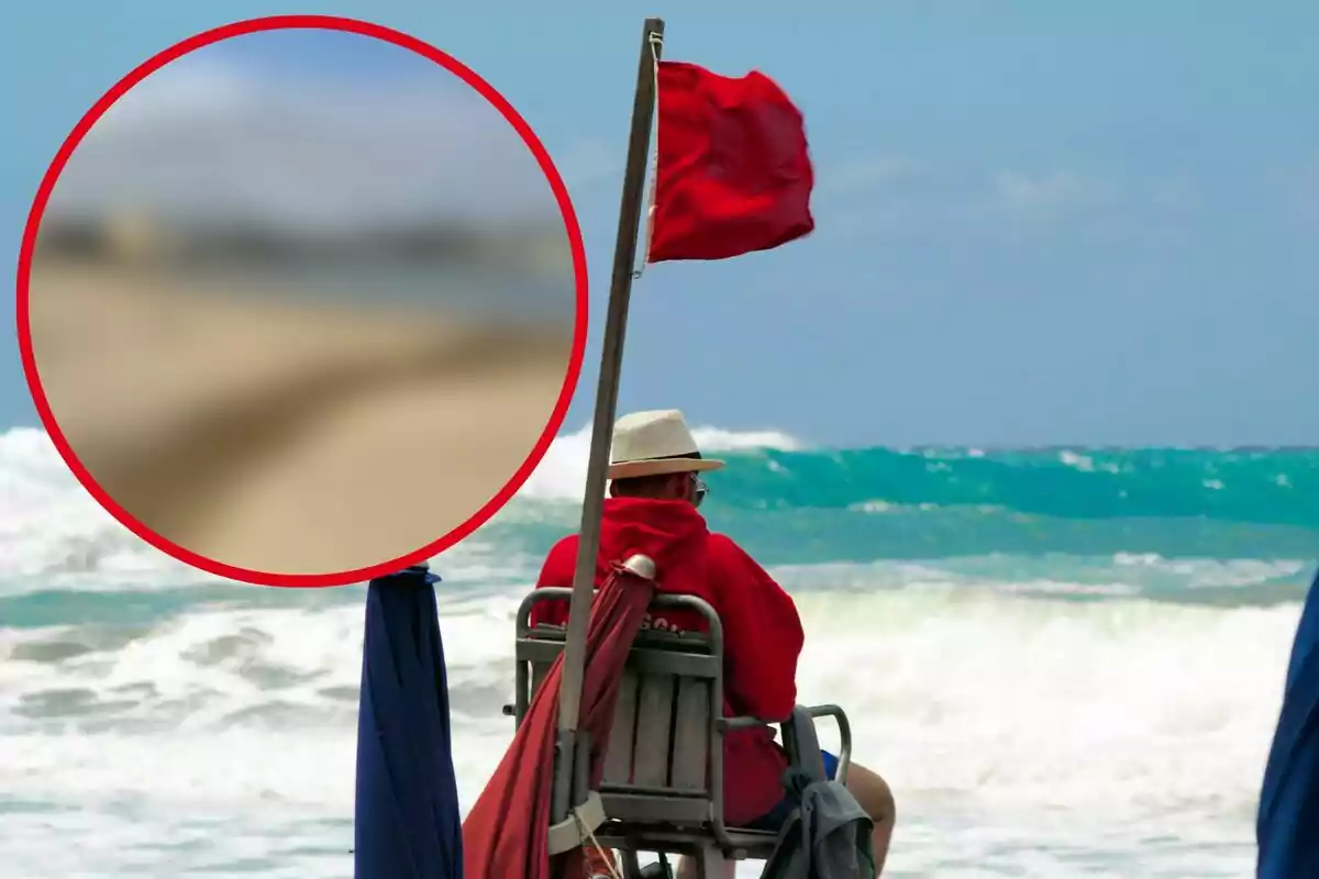 Un salvavidas sentado en una silla de vigilancia en la playa con una bandera roja ondeando indicando peligro en el mar.