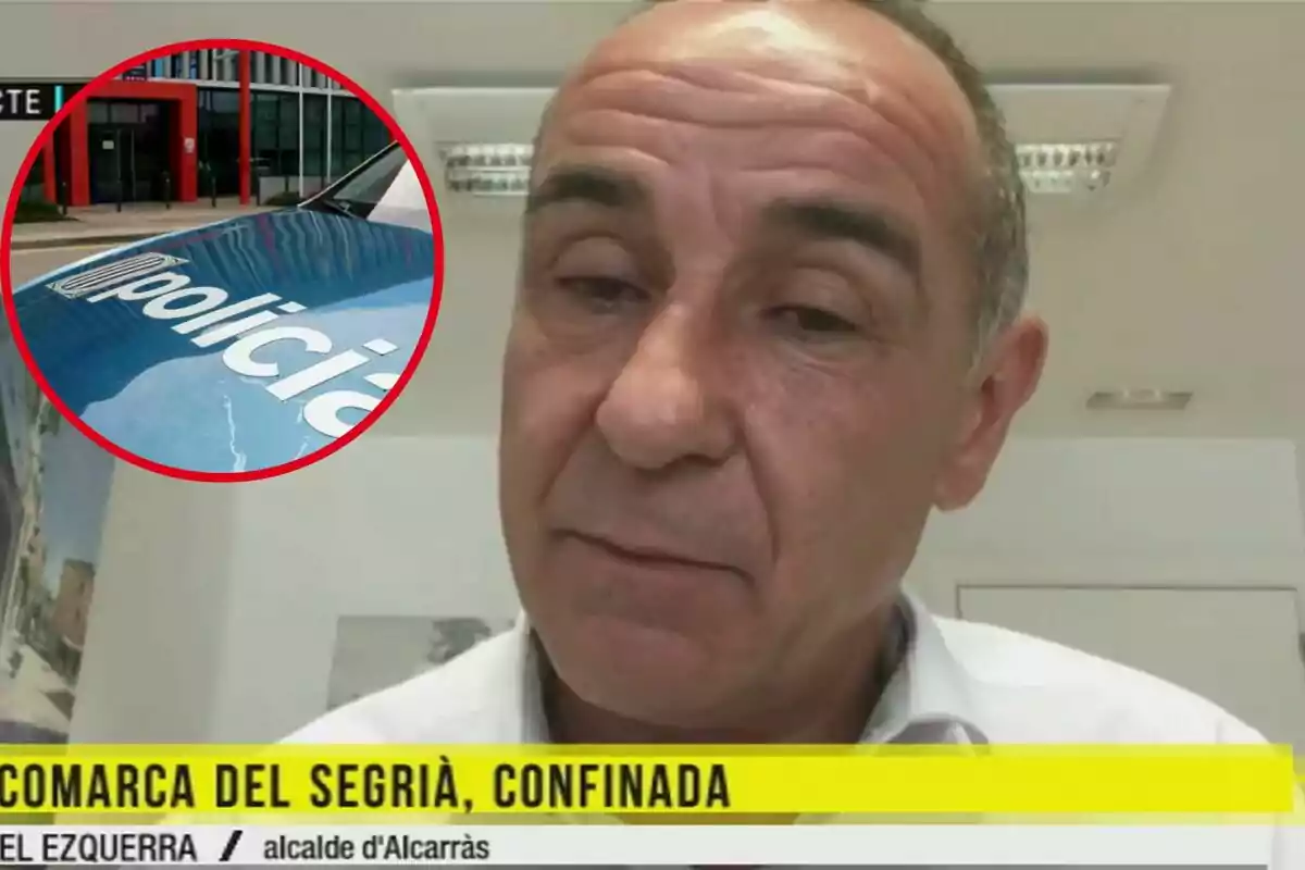 Un home apareix en una videotrucada amb un requadre que mostra una imatge d'un cotxe de policia i un edifici, amb un text a la part inferior que diu “COMARCA DEL SEGRIÀ, CONFINADA” i “JOEL EZQUERRA / alcalde d'Alcarràs”.