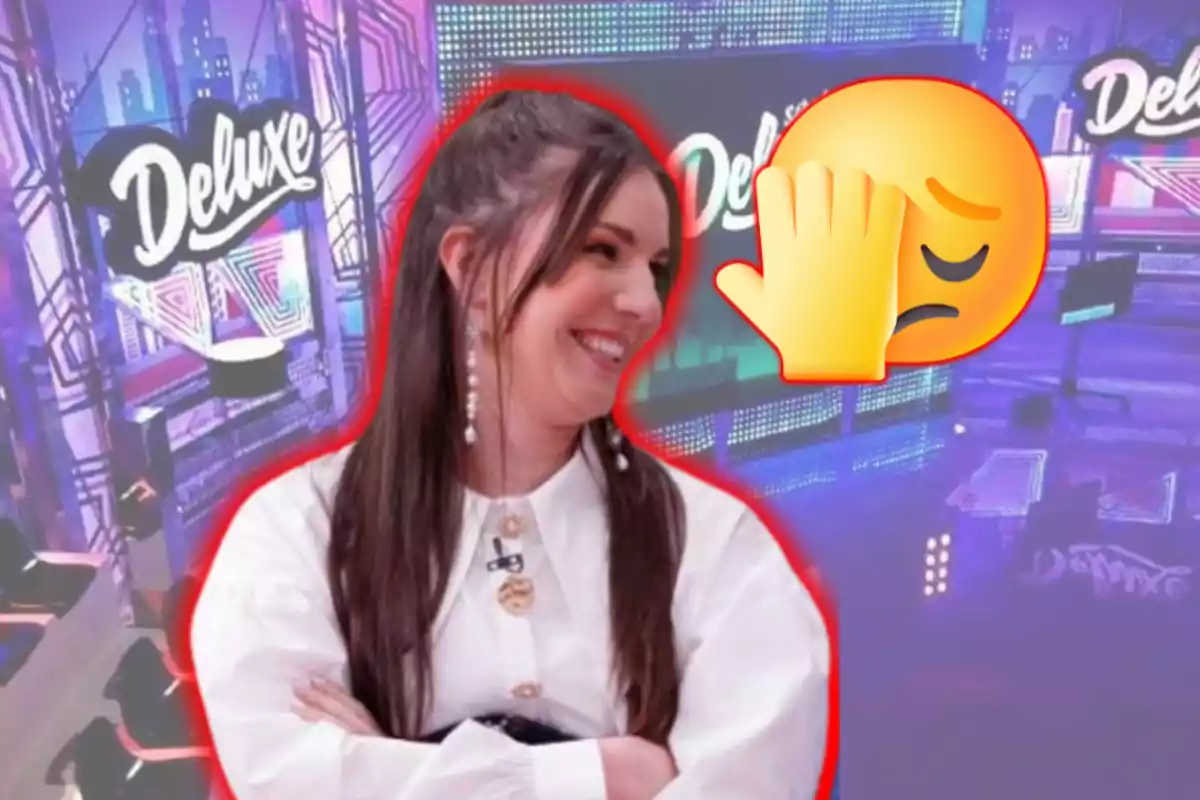 Una persona somriu en un plató de televisió amb el logotip "Deluxe" de fons i un emoji de cara amb la mà al front.