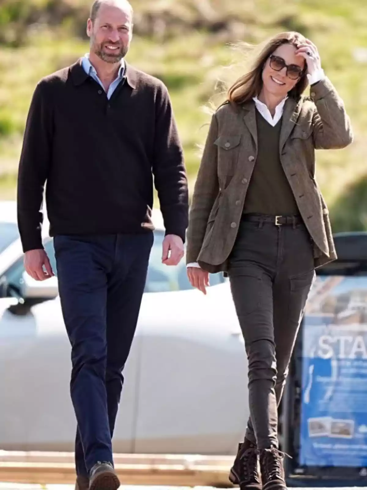 Two people walking outdoors on a sunny day, both wearing casual clothes and seeming to enjoy the moment. Two people walking outdoors on a sunny day, both wearing casual clothes and seeming to enjoy the moment.