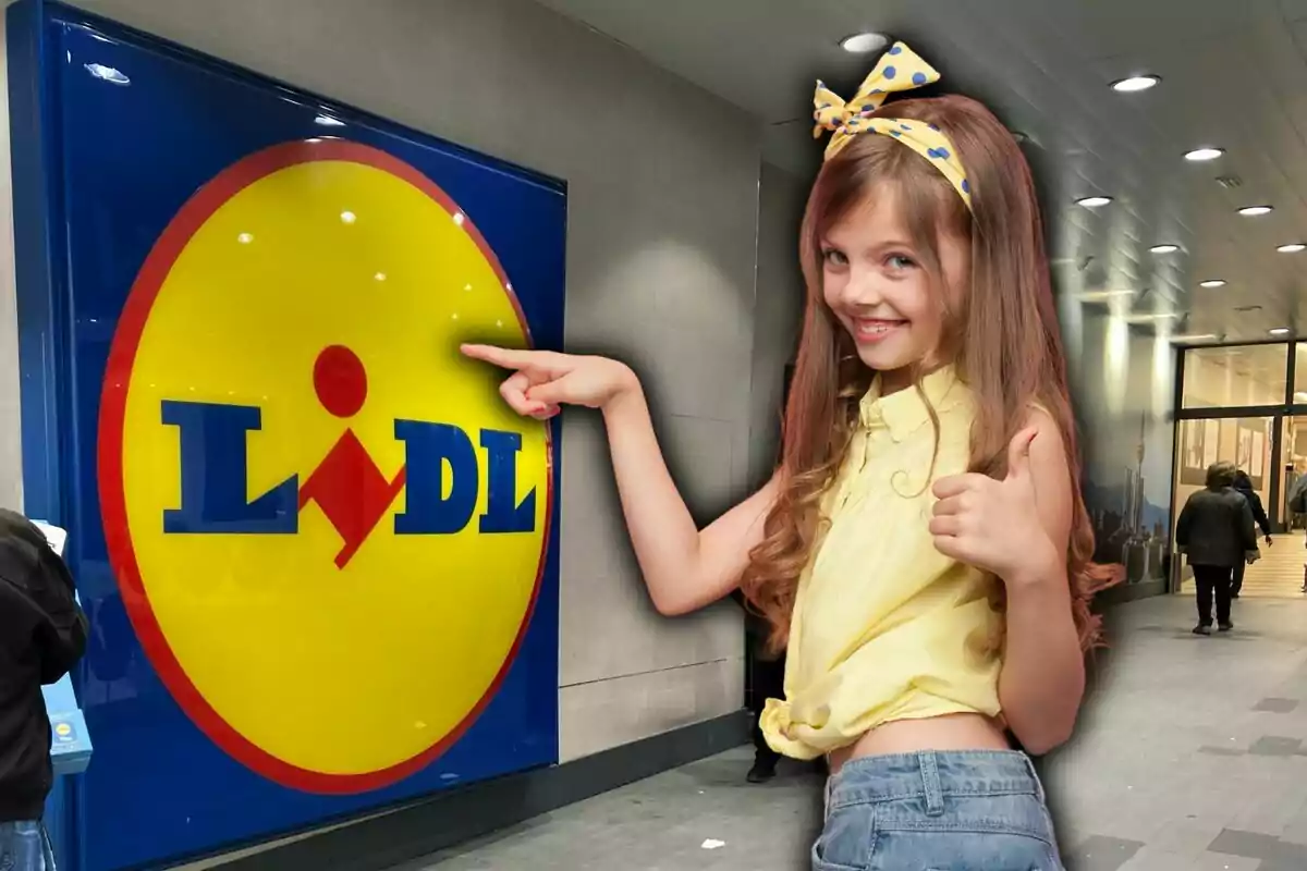 A smiling girl in a yellow blouse and a bow in her hair points with her thumb up at the Lidl logo in a store.
