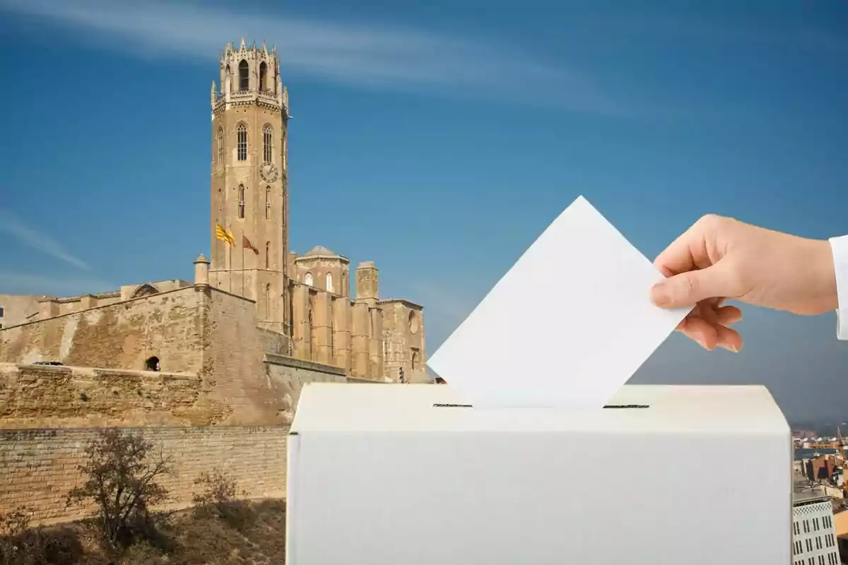 Una mano introduce un papel en una urna de votación con un edificio histórico de fondo.