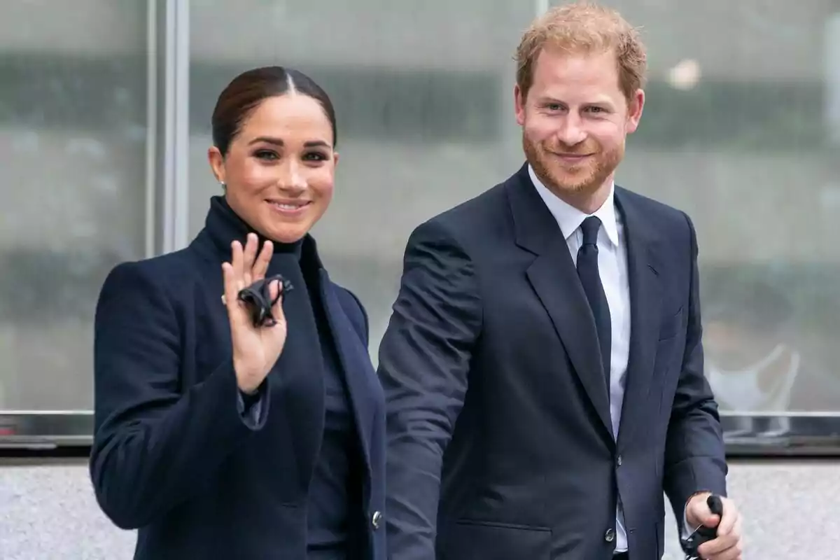 Meghan Markle and Prince Harry dressed formally, both smiling and walking together, she is waving. Meghan Markle and Prince Harry dressed formally, both smiling and walking together, she is waving.
