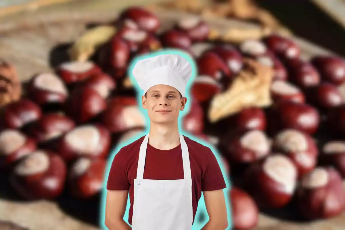 Un chef joven con delantal blanco y gorro de cocinero sonríe frente a un fondo de castañas.