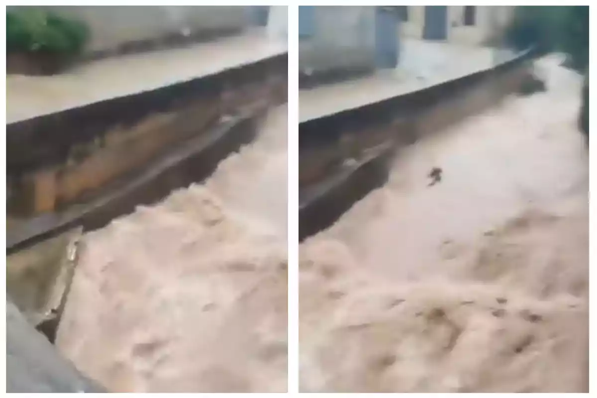 Un canal desbordat amb aigua tèrbola fluint ràpidament durant una inundació.