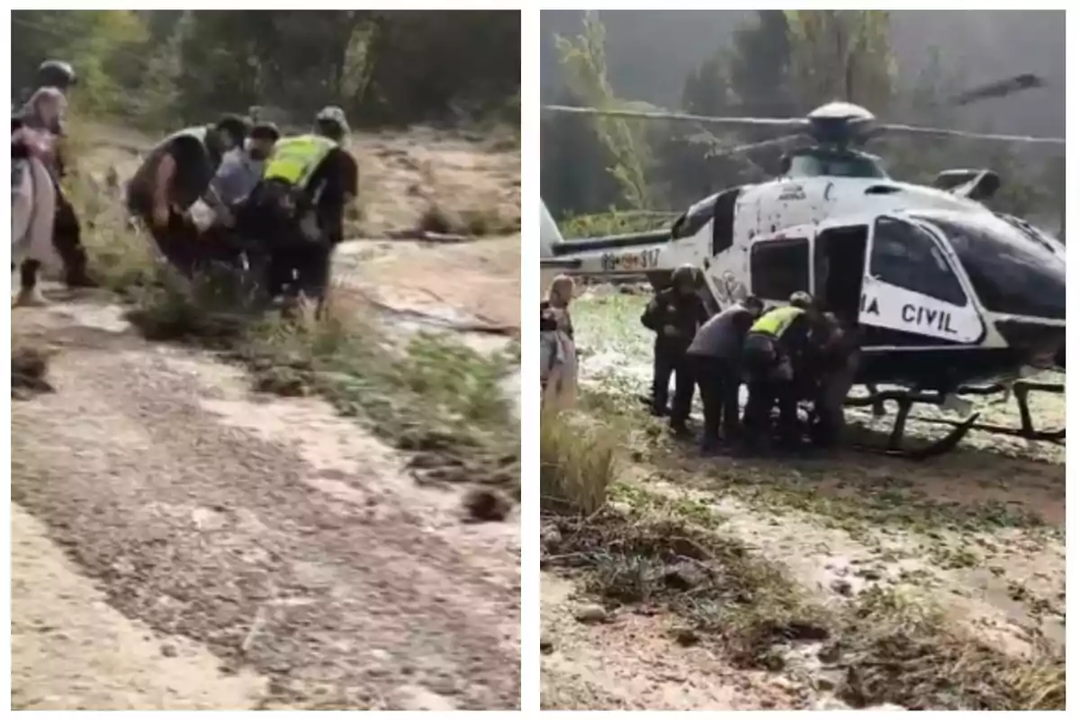 Un grupo de personas ayuda a trasladar a alguien hacia un helicóptero de la Guardia Civil en un área natural.