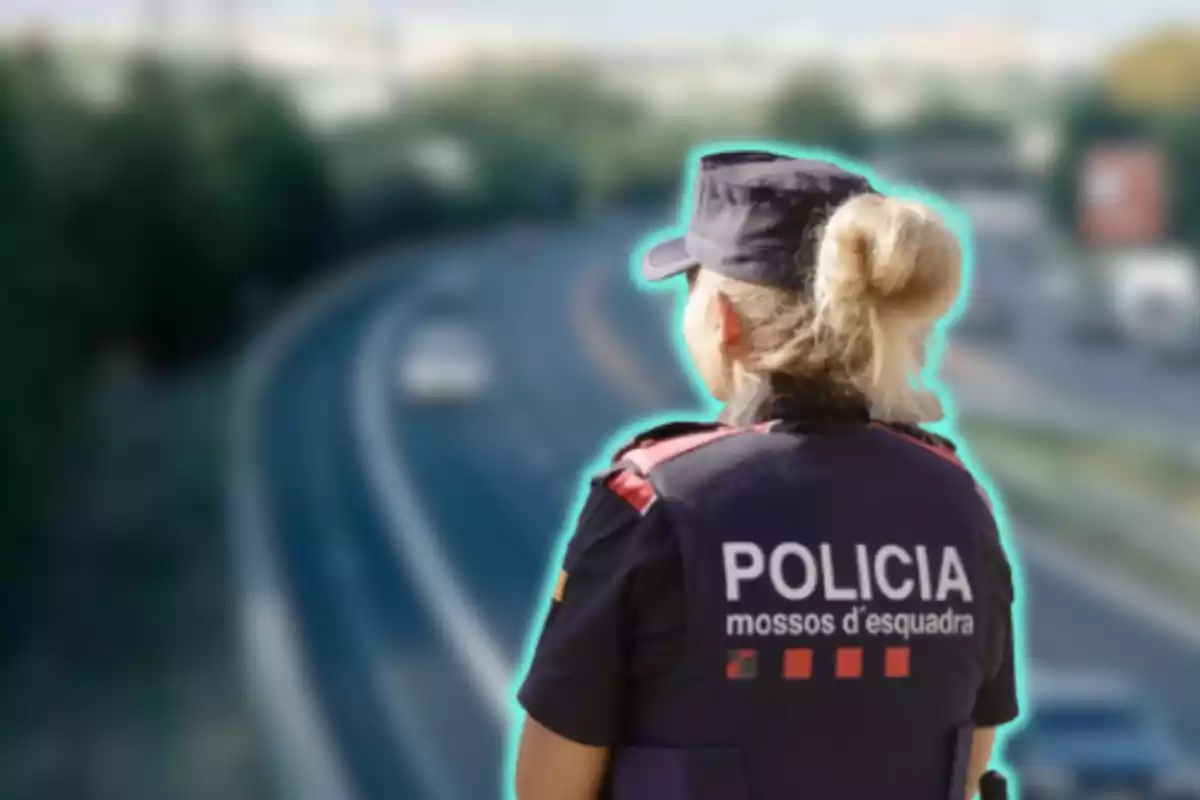 Una agent de policia dels Mossos d'Esquadra observant una carretera.