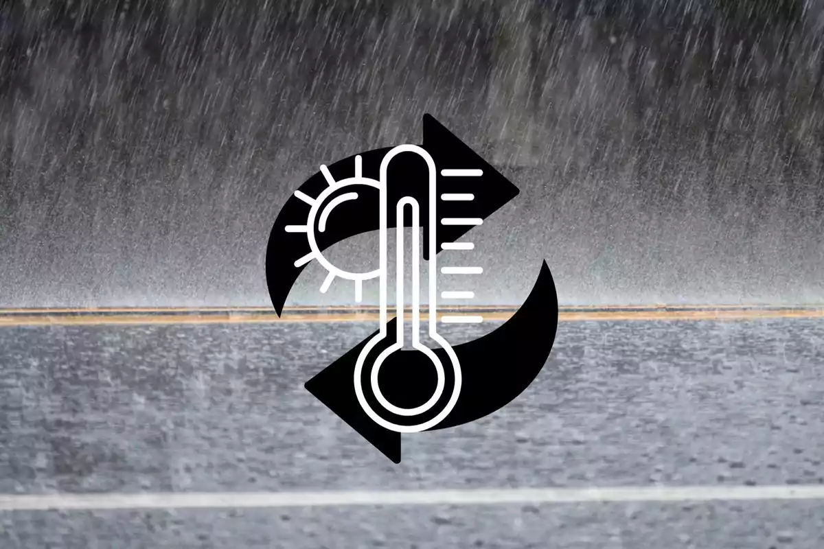 Icono de un termómetro con flechas y un sol sobre una carretera mojada bajo la lluvia.