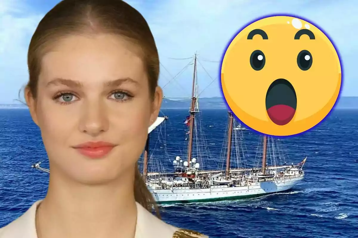Jove rossa amb uniforme davant d’un vaixell al mar i un emoji de sorpresa gran a la dreta
