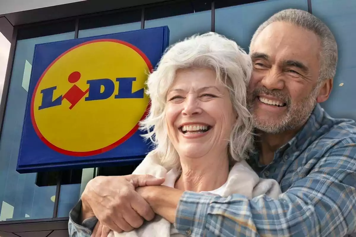 A smiling couple hugs in front of a Lidl sign.