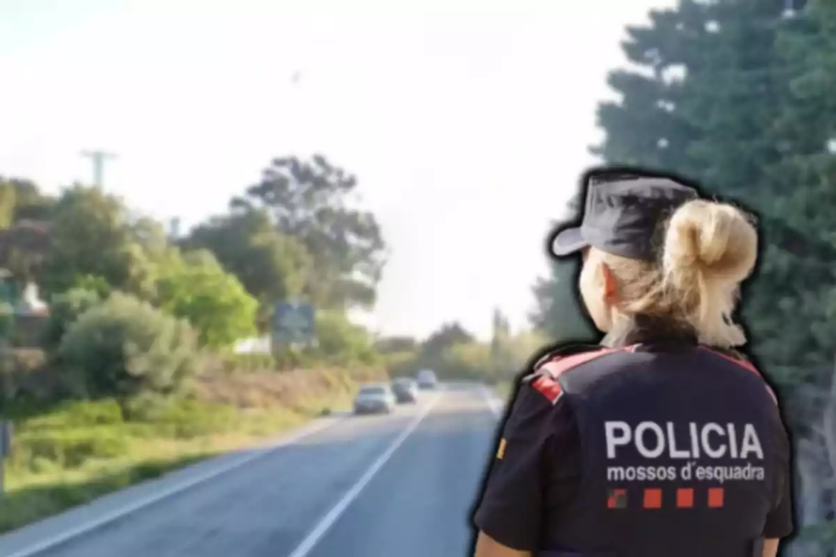 Una agente de policía de espaldas en una carretera rodeada de árboles.