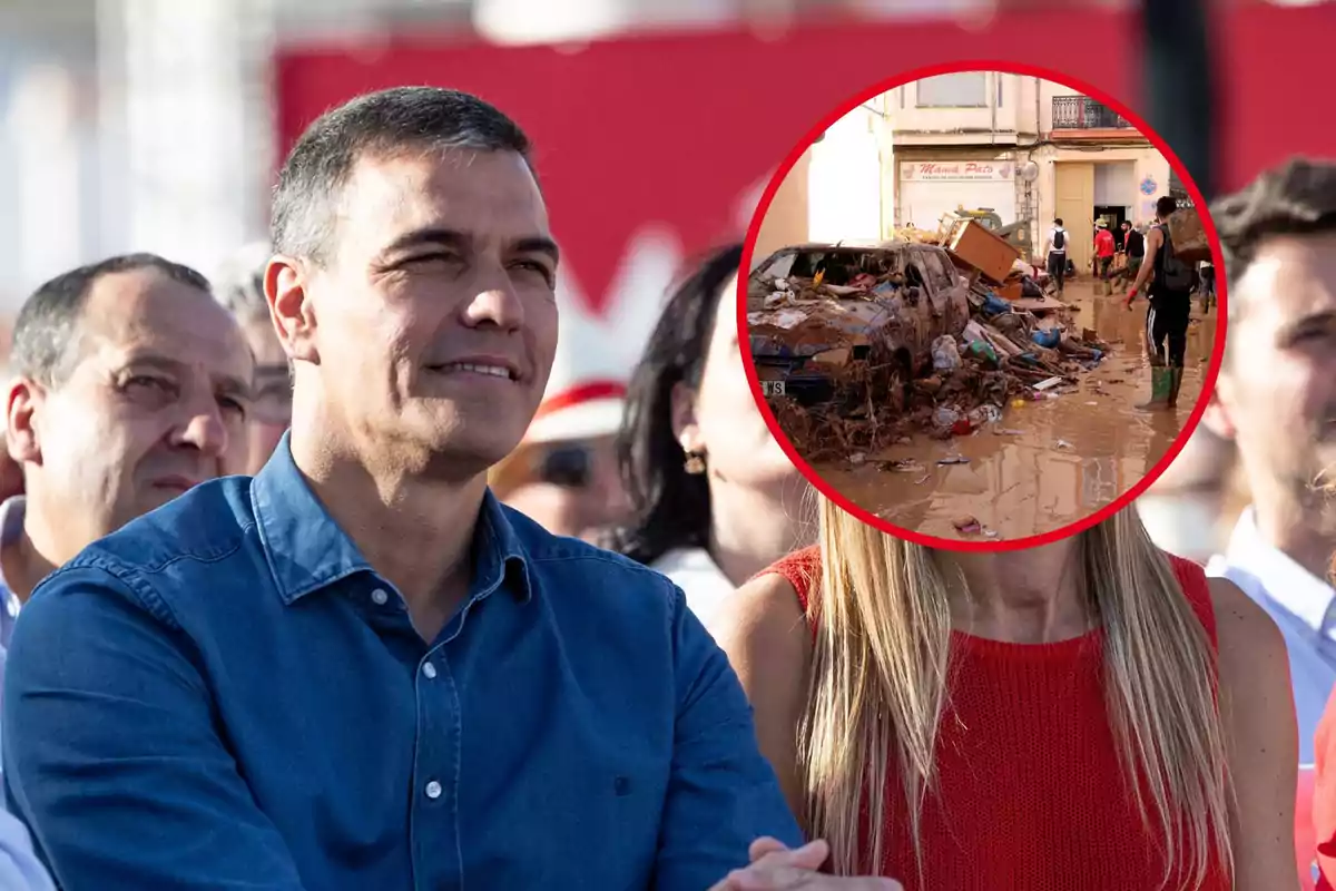 Un grupo de personas observa mientras una imagen circular muestra una calle inundada con escombros y un coche dañado.