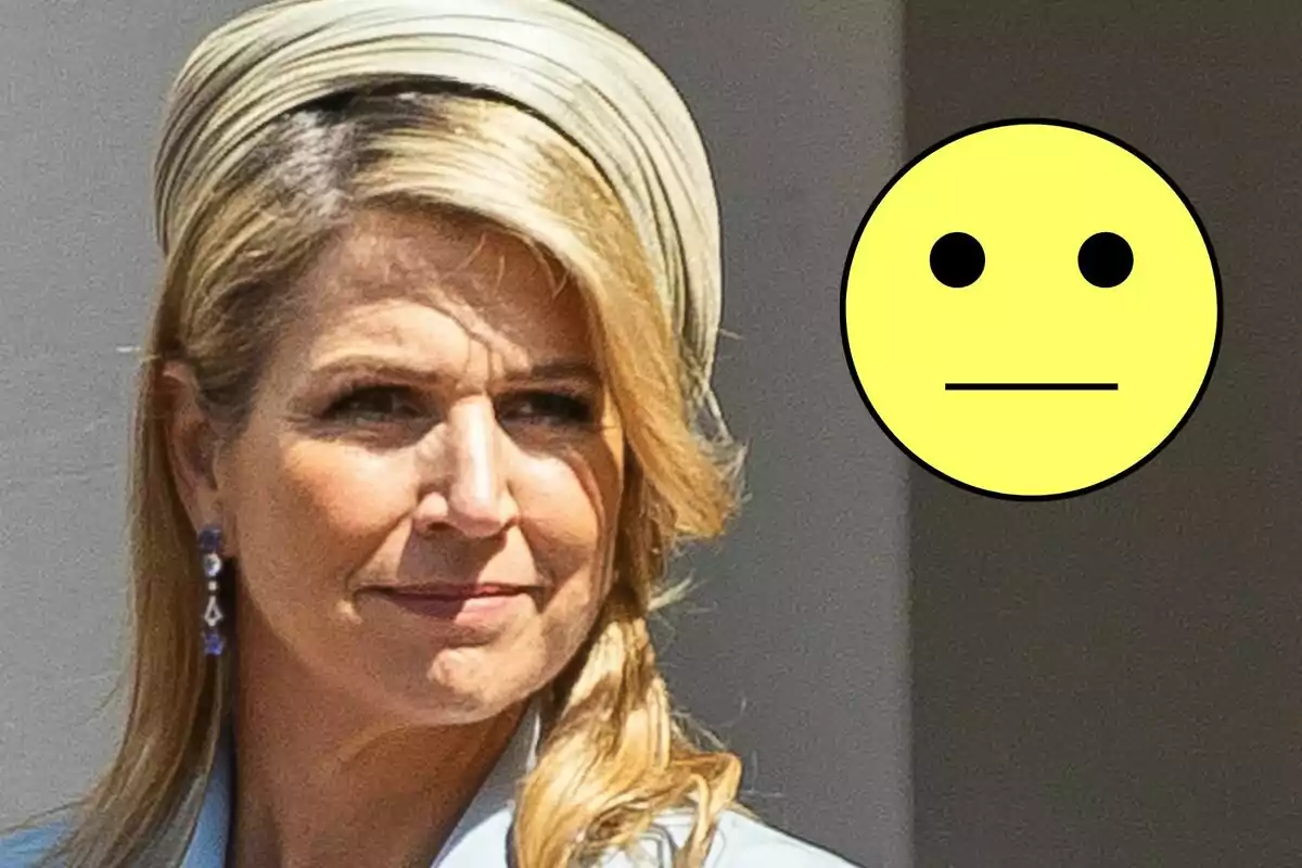 Máxima de Holanda con sombrero claro y emoji amarillo con expresión neutral.