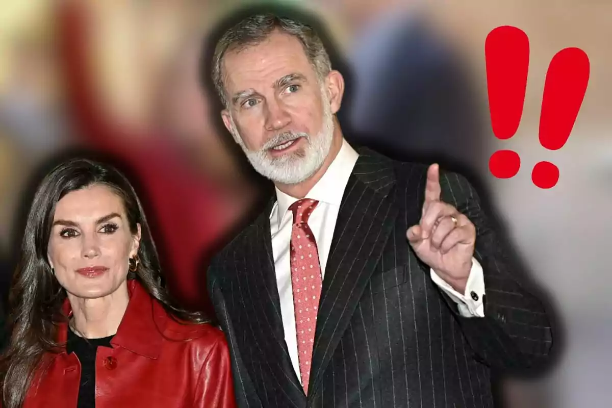 La reina Letizia y Felipe VI vestida formalmente, con un fondo desenfocado y dos signos de exclamación rojos a la derecha.