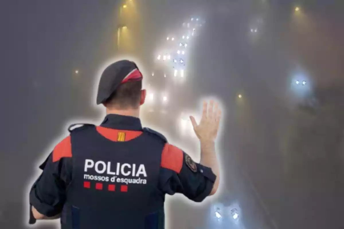 Un agent dels Mossos i una carretera coberta per la boira.